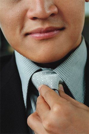 executive mentor - A man adjusts his tie Stock Photo - Premium Royalty-Free, Code: 656-01766267