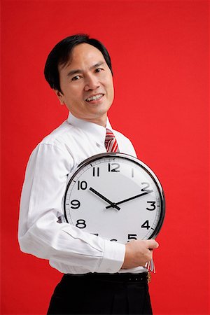 A man holds a clock Stock Photo - Premium Royalty-Free, Code: 656-01766277