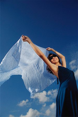A young woman dances in the wind with a veil Stock Photo - Premium Royalty-Free, Code: 656-01766312