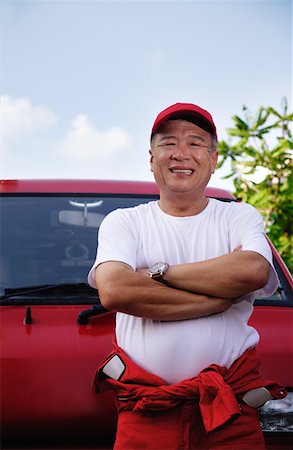 A man with a red van smiles at the camera as he works Foto de stock - Sin royalties Premium, Código: 656-01766457
