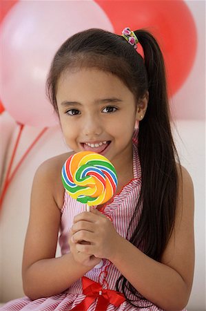 A young girl at a party with balloons Stock Photo - Premium Royalty-Free, Code: 656-01766489