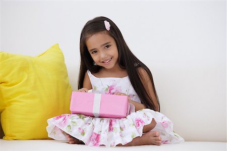 exotic relaxing - A young girl with a birthday present Stock Photo - Premium Royalty-Free, Code: 656-01766545