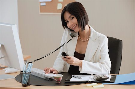 simsearch:656-01766255,k - A woman talks on the phone while she is at work Stock Photo - Premium Royalty-Free, Code: 656-01766553