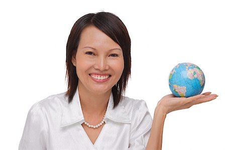 Woman holding globe and smiling at camera Stock Photo - Premium Royalty-Free, Code: 656-01766759