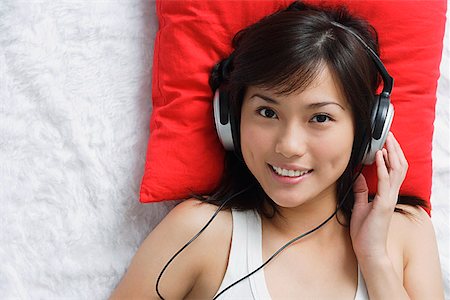 someone laying down aerial view - Young woman listening to music Stock Photo - Premium Royalty-Free, Code: 656-01766788