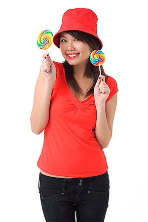 simsearch:640-03257317,k - Young woman with lollipop smiling at camera Fotografie stock - Premium Royalty-Free, Codice: 656-01766826