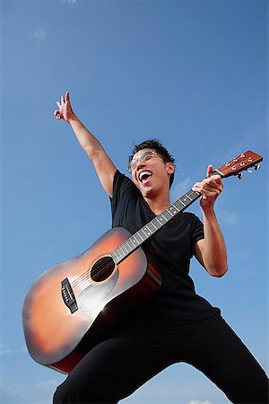 Man playing guitar outdoors Stock Photo - Premium Royalty-Free, Code: 656-01766923