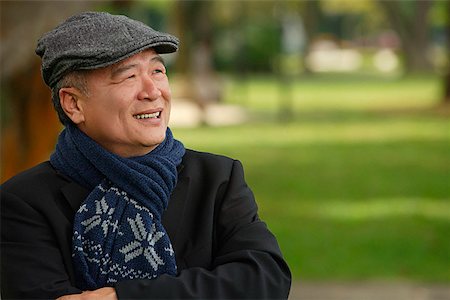 senior man portrait scarf - Man in the park smiling into distance Stock Photo - Premium Royalty-Free, Code: 656-01766953