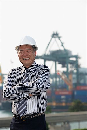 engineer standing with arms crossed - Man with helmet and arms crossed, looking at camera Stock Photo - Premium Royalty-Free, Code: 656-01766966