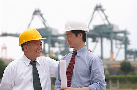 Men with helmets looking at each other Stock Photo - Premium Royalty-Free, Code: 656-01767045