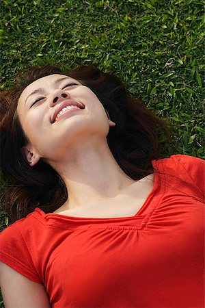 someone laying down aerial view - Woman smiling, lying on grass Stock Photo - Premium Royalty-Free, Code: 656-01767062
