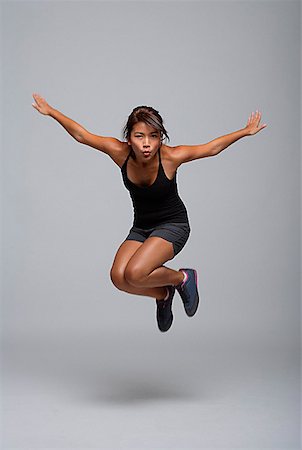 energized - Young woman jumping up Stock Photo - Premium Royalty-Free, Code: 656-01767197