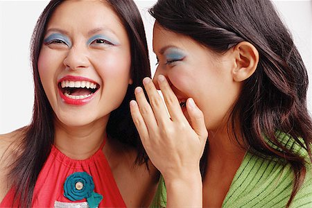 singapore women 30s - Two women, one laughing, the other whispering in her ear Stock Photo - Premium Royalty-Free, Code: 656-01767288