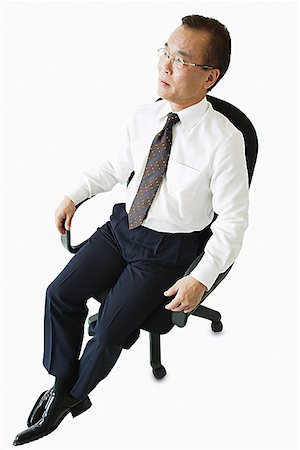 Businessman sitting on office chair Stock Photo - Premium Royalty-Free, Code: 656-01767631