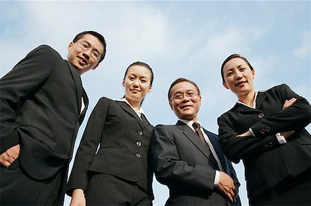 simsearch:693-03304499,k - Businessmen and businesswomen looking down at camera Stock Photo - Premium Royalty-Free, Code: 656-01767656