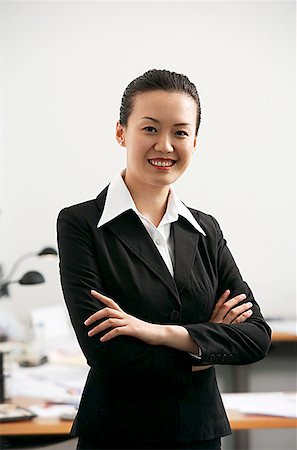 singapore women 30s - Businesswoman standing with arms crossed, smiling at camera Stock Photo - Premium Royalty-Free, Code: 656-01767673