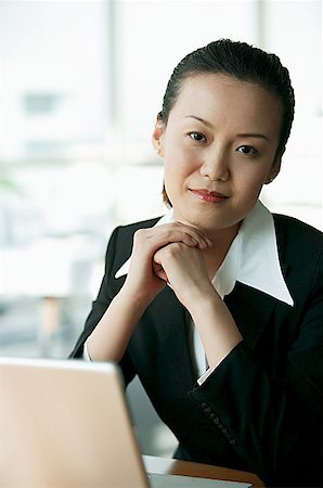 singapore women 30s - Businesswoman looking at camera, hands clasped Stock Photo - Premium Royalty-Free, Code: 656-01767685