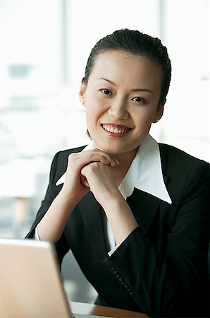 executive mentor - Businesswoman smiling at camera, hands clasped Stock Photo - Premium Royalty-Free, Code: 656-01767686