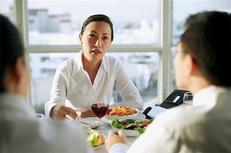 female hero - Businesswoman facing other executives over lunch table Stock Photo - Premium Royalty-Free, Code: 656-01767694