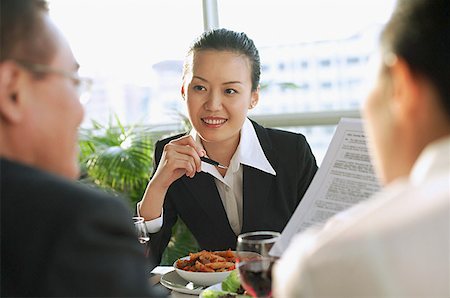 singapore women 30s - Executives having a meeting over lunch Stock Photo - Premium Royalty-Free, Code: 656-01767705