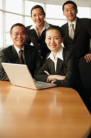 portrait of happy mature businessman standing arms crossed in office - Group of executives, in boardroom smiling at camera, portrait Stock Photo - Premium Royalty-Free, Code: 656-01767724