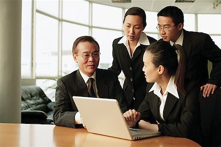 Executives in office, having a meeting, laptop open in front of them Stock Photo - Premium Royalty-Free, Code: 656-01767721