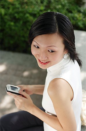 simsearch:656-01766118,k - Young woman, holding mobile phone high angle view Foto de stock - Royalty Free Premium, Número: 656-01767796