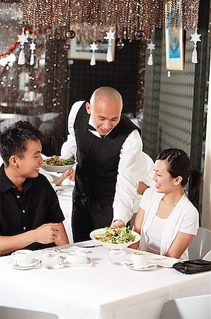 simsearch:656-01767905,k - Waiter serving couple at restaurant Fotografie stock - Premium Royalty-Free, Codice: 656-01767843