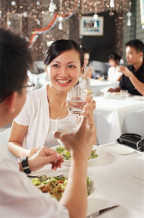 simsearch:656-01772966,k - Couple at restaurant, holding glasses of water, over the shoulder view Stock Photo - Premium Royalty-Free, Code: 656-01767850
