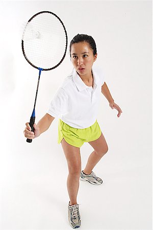 simsearch:656-01767955,k - Woman hitting shuttlecock with badminton racket Foto de stock - Sin royalties Premium, Código: 656-01767959