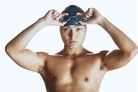 Man adjusting swimming goggles, looking at camera, portrait Stock Photo - Premium Royalty-Free, Code: 656-01767968