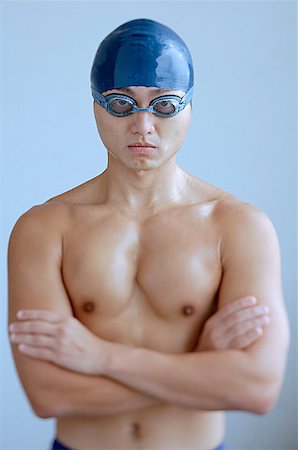 simsearch:656-03241028,k - Man wearing swimming cap and goggles, arms crossed, looking at camera Foto de stock - Sin royalties Premium, Código: 656-01767961