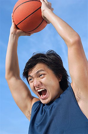 simsearch:656-01765624,k - Man holding basketball up, shouting Stock Photo - Premium Royalty-Free, Code: 656-01767991