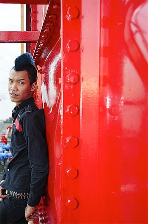 singapore wonder - Man with mohawk, leaning on wall, looking at camera Stock Photo - Premium Royalty-Free, Code: 656-01768025