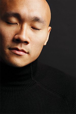 eyes closed portrait of asian man - Man with shaved head, eyes closed head shot Stock Photo - Premium Royalty-Free, Code: 656-01768026