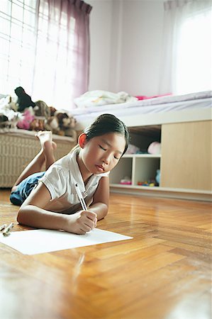 simsearch:656-01768333,k - Girl in bedroom, lying on floor, drawing on paper Stock Photo - Premium Royalty-Free, Code: 656-01768160