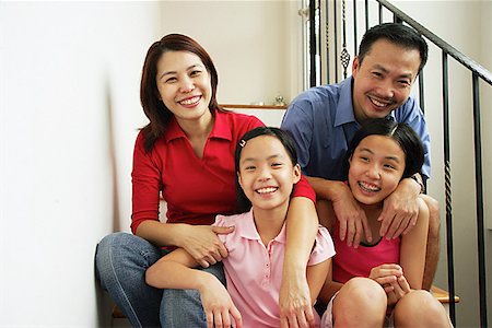 family condo - Family with two girls, smiling at camera Stock Photo - Premium Royalty-Free, Code: 656-01768236