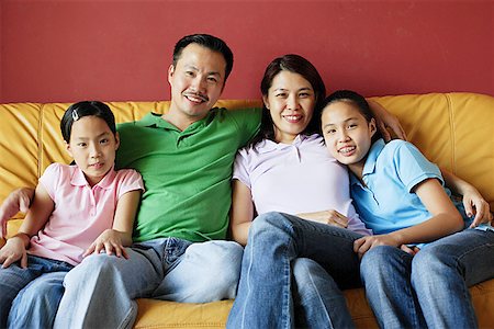 simsearch:656-01768177,k - Family of four sitting on sofa, looking at camera Stock Photo - Premium Royalty-Free, Code: 656-01768294