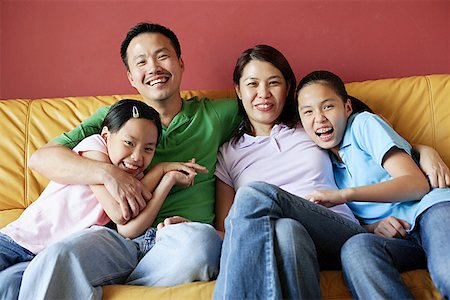 family condo - Family of four sitting on sofa, family portrait Stock Photo - Premium Royalty-Free, Code: 656-01768295