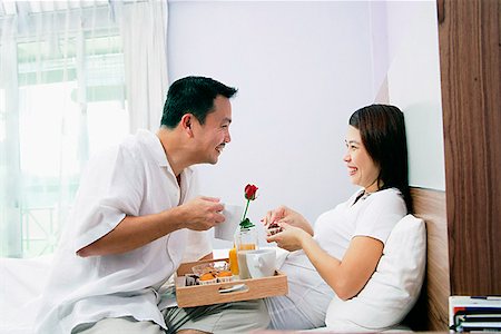 simsearch:656-01765502,k - Couple in bedroom, breakfast tray between them Stock Photo - Premium Royalty-Free, Code: 656-01768310