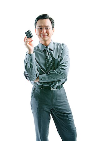 eye glasses images investing - Businessman holding credit card, arms crossed, looking at camera Stock Photo - Premium Royalty-Free, Code: 656-01768354