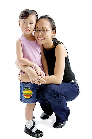 skirt crouch - Young girl standing, mother crouching next to her, looking at camera Stock Photo - Premium Royalty-Free, Code: 656-01768378