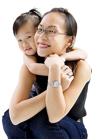 skirt crouch - Mother and daughter embracing, smiling at camera Stock Photo - Premium Royalty-Free, Code: 656-01768379