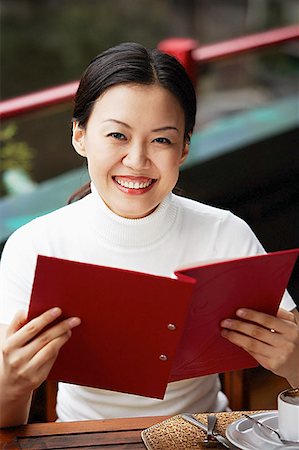 Women in cafe, holding menu, smiling at camera Stock Photo - Premium Royalty-Free, Code: 656-01768466