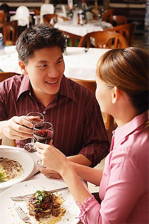 Couple in restaurant, toasting with drinks Stock Photo - Premium Royalty-Free, Code: 656-01768497