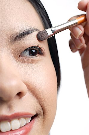 Woman applying eyeshadow, close- up Stock Photo - Premium Royalty-Free, Code: 656-01768593