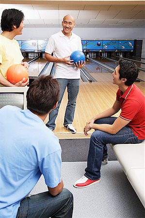 Four men in bowling alley Stock Photo - Premium Royalty-Free, Code: 656-01768718