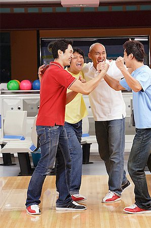 Four guys at a bowling alley, celebrating Stock Photo - Premium Royalty-Free, Code: 656-01768727