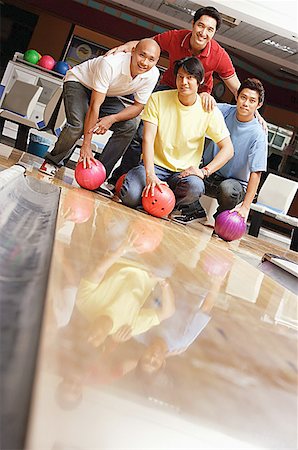 Four men in bowling alley, looking at camera Stock Photo - Premium Royalty-Free, Code: 656-01768737