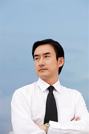 portrait man 50s looking away outdoors - Businessman with arms crossed, looking away Stock Photo - Premium Royalty-Free, Code: 656-01768792